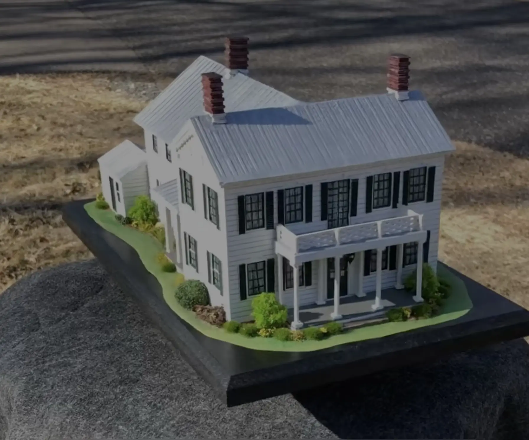 Replica of a New York farmhouse with wraparound porch