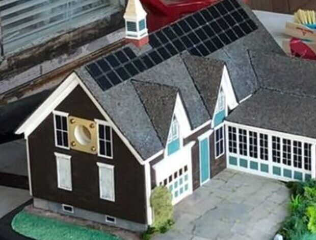 Model home replica with solar panels.